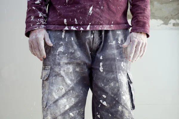 Mãos calças sujas de reboco homem pintor — Fotografia de Stock