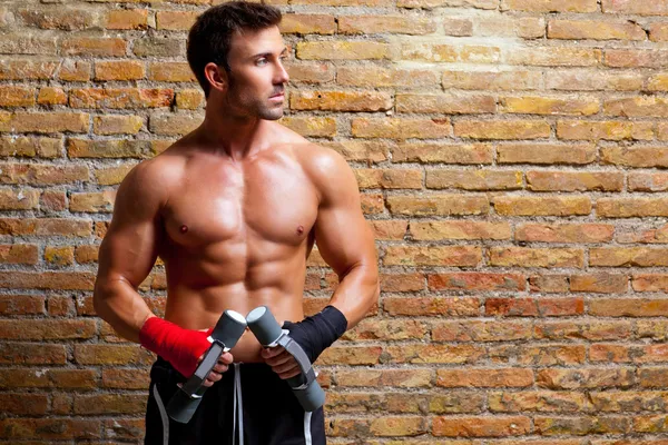 Hombre boxeador muscular con vendaje de puño y pesas — Foto de Stock
