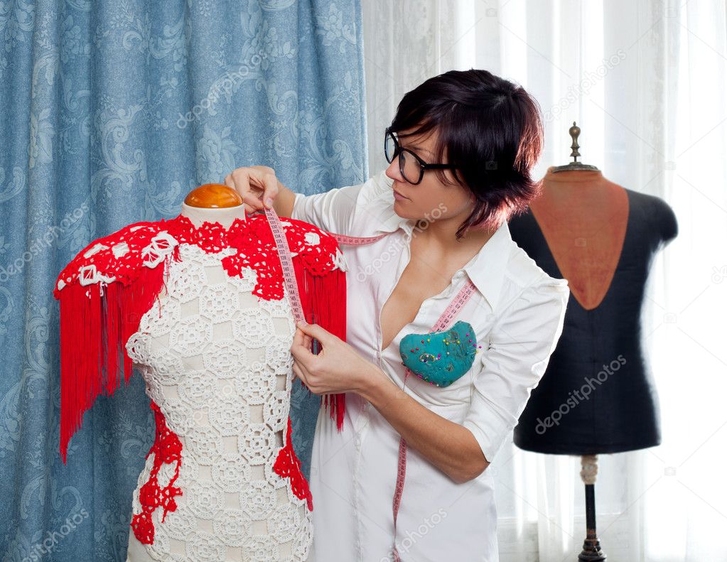 Dressmaker with mannequin working at home