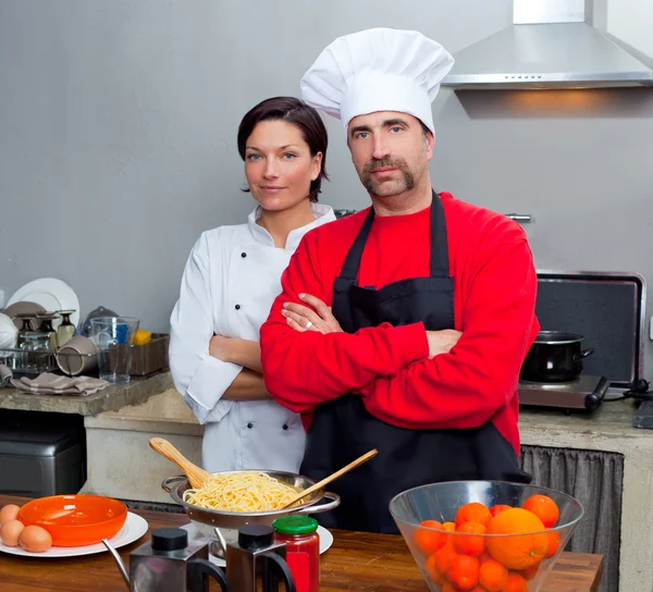 Шеф-повар пара мужчина и женщина позируют на кухне — стоковое фото