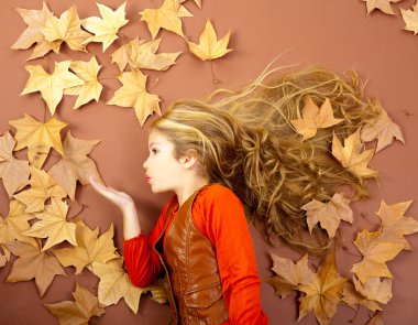 Autumn girl on dried leaves blowing wind lips clipart