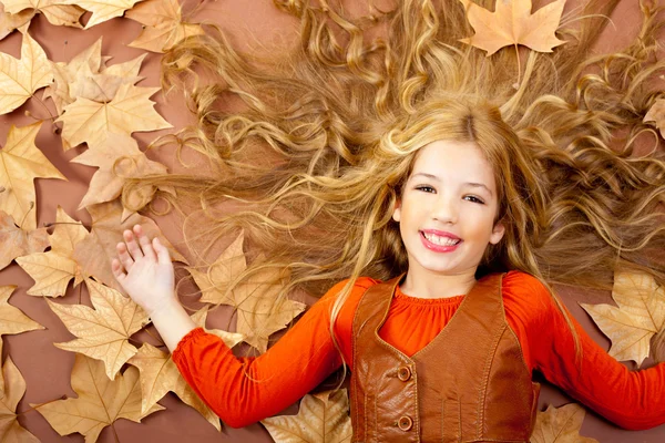 Autumn fall little blond girl on dried tree leaves — Stock Photo, Image