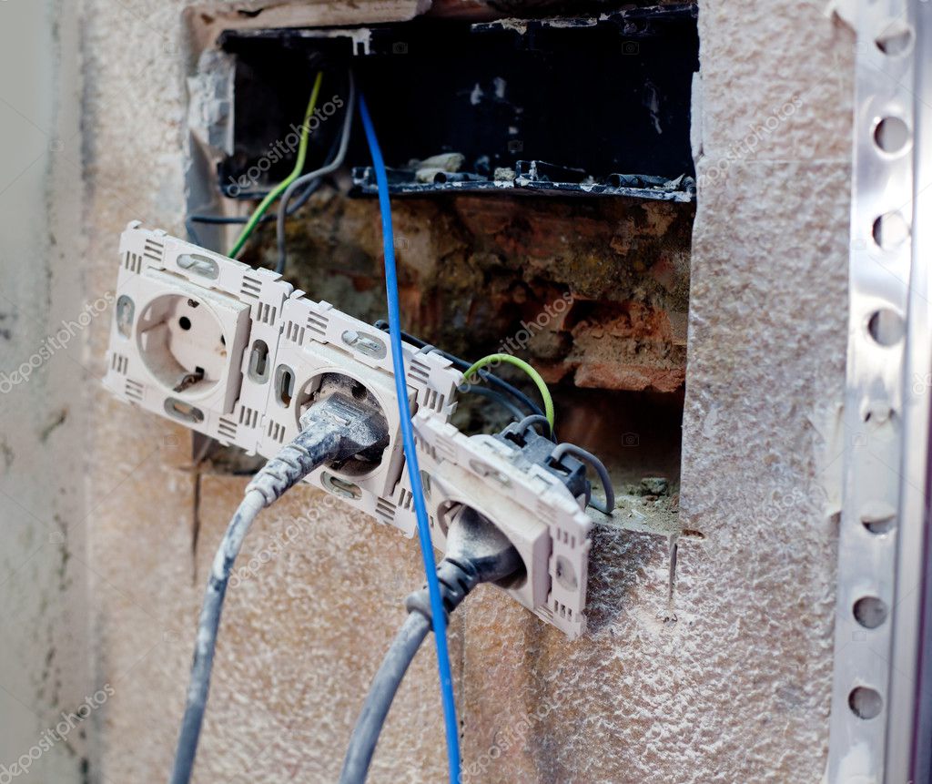 Electrical coil conduit pipe on box embedded in wall Stock Photo