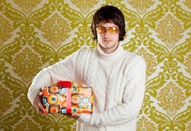 Retro hip young man glasses holding gift box clipart