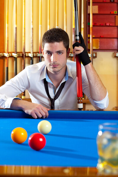 Billiard expertise man posing on blue