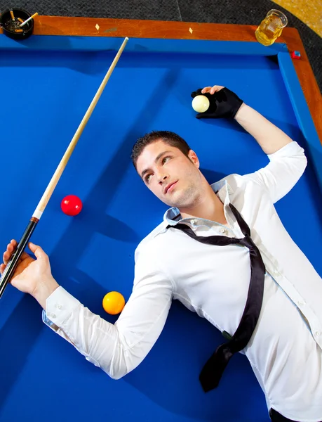 Billiard young man player lying on pool blue table — Stock Photo, Image