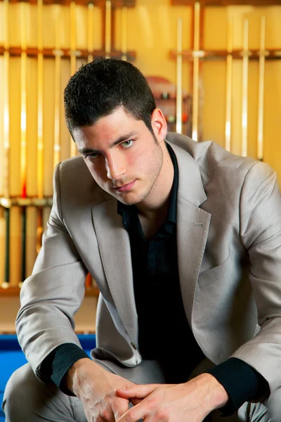 Handsome man with suit sitting in billiard pool — Stock Photo, Image