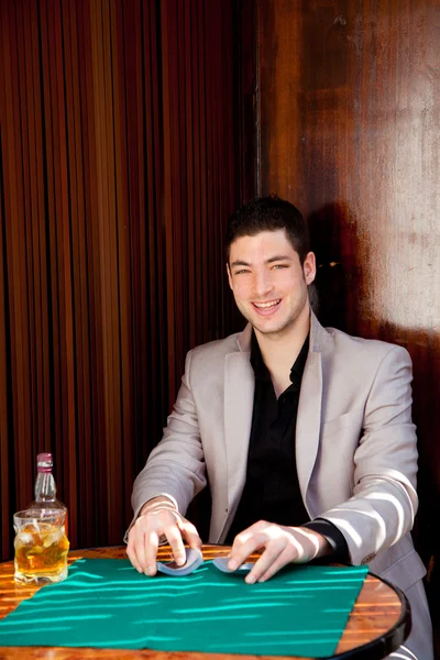 Latim bonito jogador homem na mesa jogando poker — Fotografia de Stock