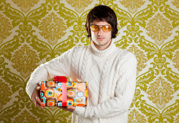 Retro hip young man glasses holding gift box