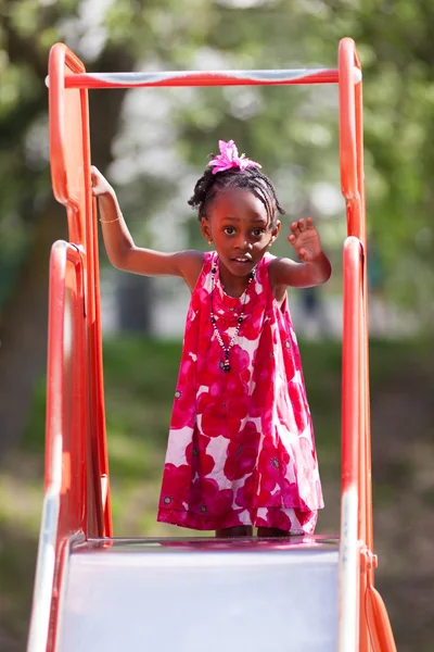 Portrait of a cute african american little girl playing at playg — Stock Photo, Image