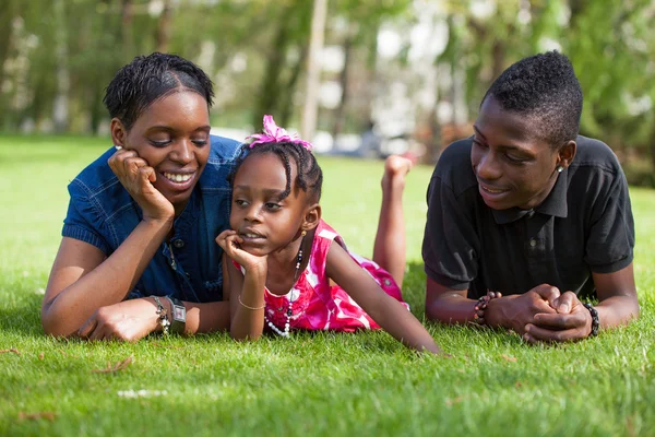 Adorable african mother with her childrens in the garden — Stock Photo, Image