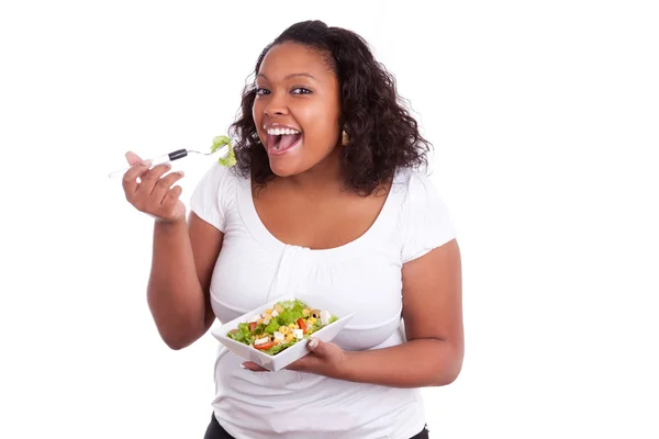 Young african american woman eating salad — Stock Photo, Image