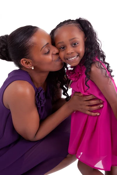 Happy african mother kissing her daughter — Stock Photo, Image