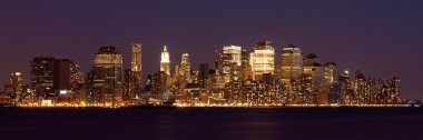 New York - Panoramic view of Manhattan Skyline by night clipart