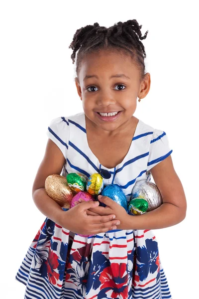 Little african american girl holding chocolate easter eggs — Stock Photo, Image