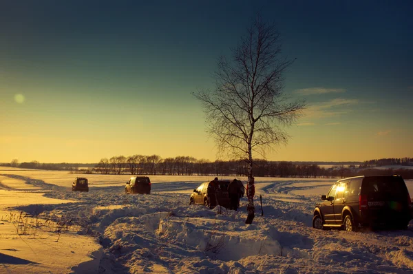 Quatro SUV em um pôr do sol de inverno — Fotografia de Stock