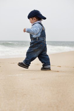 Young child walking on a beach