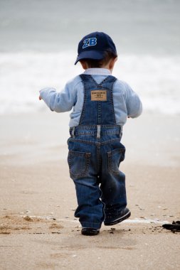 Young child walking on a beach