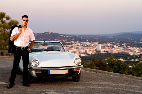 Man with white convertible Royalty Free Stock Images