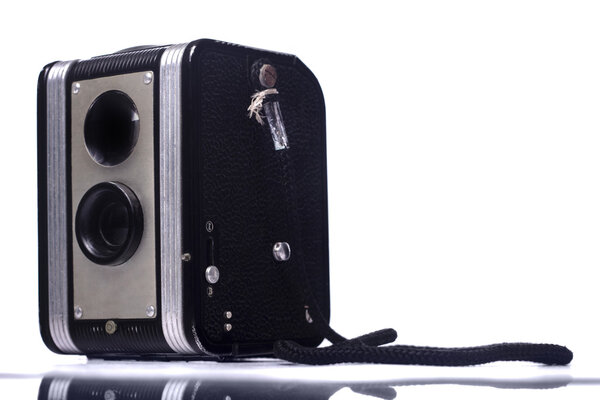 Close view of a vintage dual lenses reflex camera isolated on a white background.