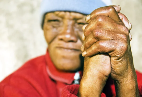 stock image Old African woman with folded hands - focus on the weathered hands