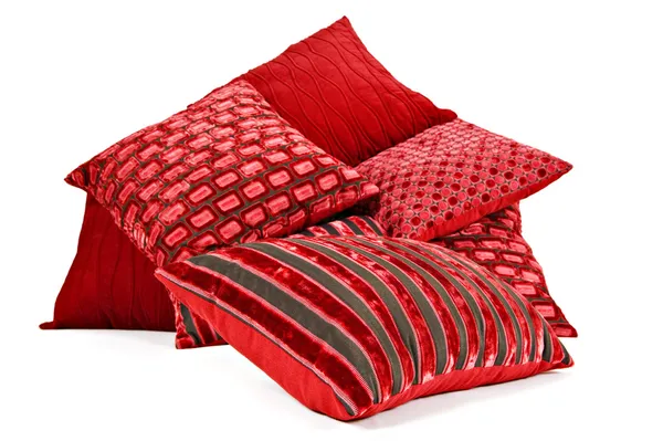 stock image Red cushions stacked up on a white background