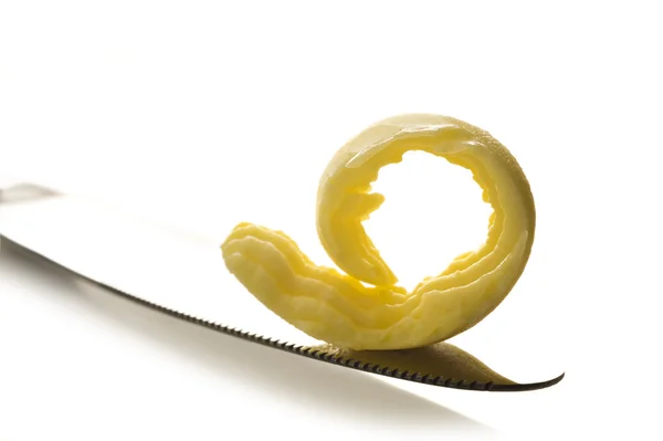 Curl of butter on a knife tip — Stock Photo, Image