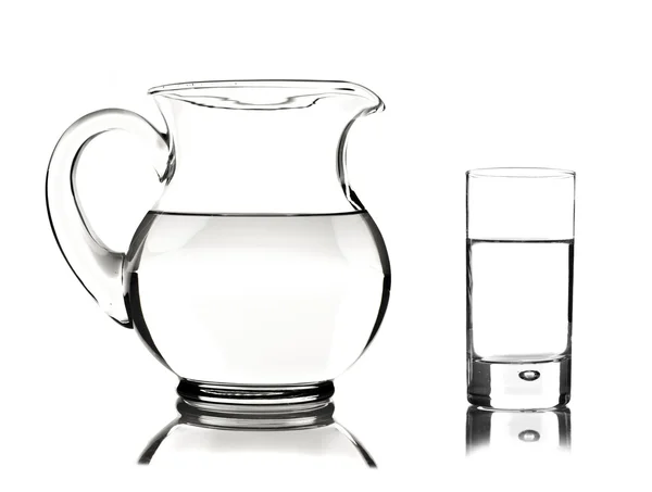 Glass and glass pitcher on white background — Stock Photo, Image