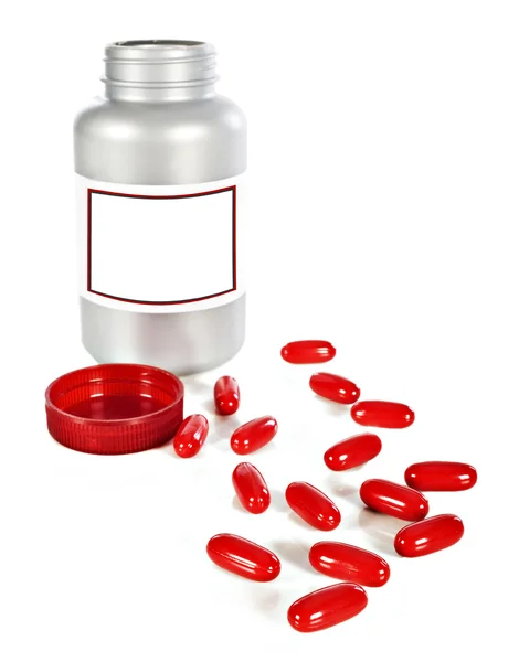 Бутылка красных таблеток на белом фоне с местом для текста — стоковое фото