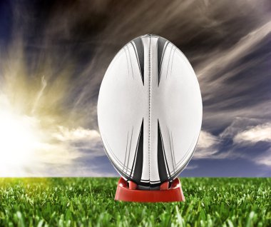 Rugby ball ready to be kicked on the field clipart