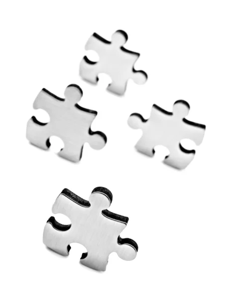 Roestvrij staal puzzels stukken op witte achtergrond — Stockfoto