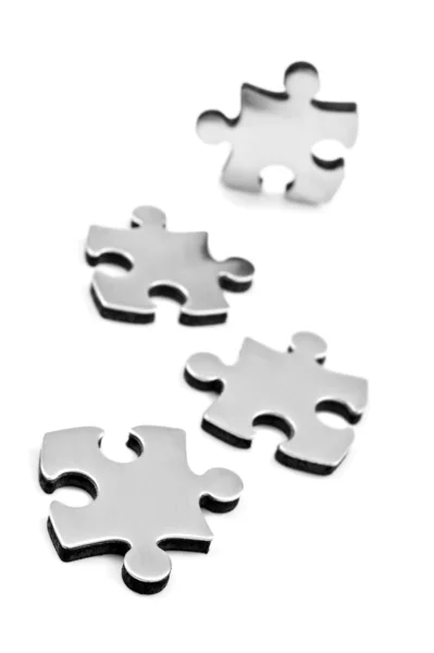Roestvrij staal puzzels stukken op witte achtergrond — Stockfoto