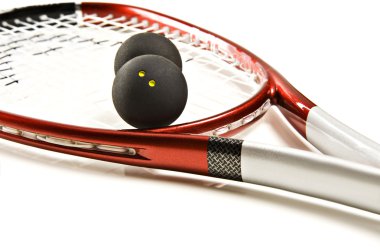 Close up of a red and silver squash racket and ball on a white background with space for text clipart