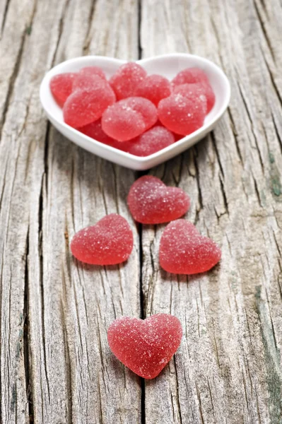 Red heart shaped jelly sweets on wood — Stock Photo, Image