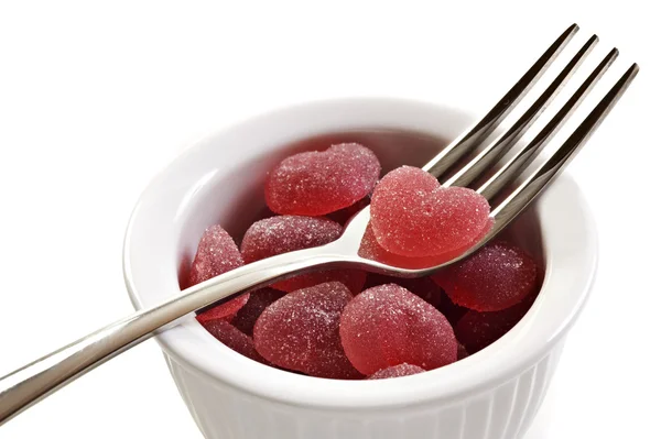 Red heart shaped jelly sweets with fork — Stock Photo, Image
