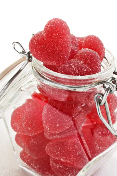 Red heart shaped jelly sweet in a glass jar — Stock Photo, Image