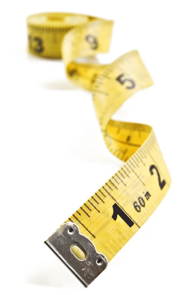 Yellow tape meassure on rolled up on white background — Stock Photo, Image