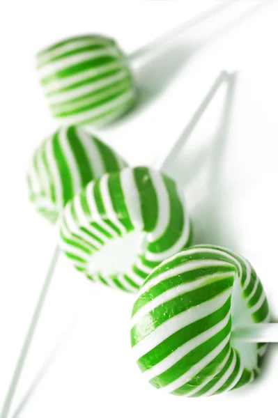 Green and white candy lolly pops on white background — Stock Photo, Image