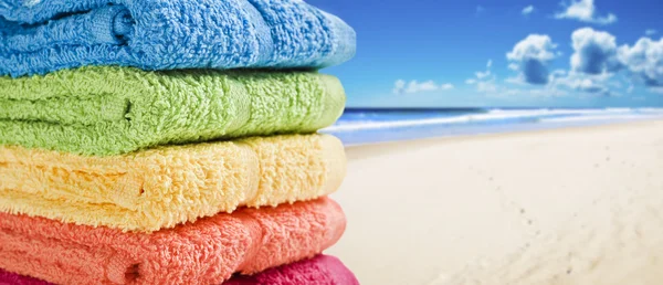 Colorful towels on a white beach Royalty Free Stock Photos