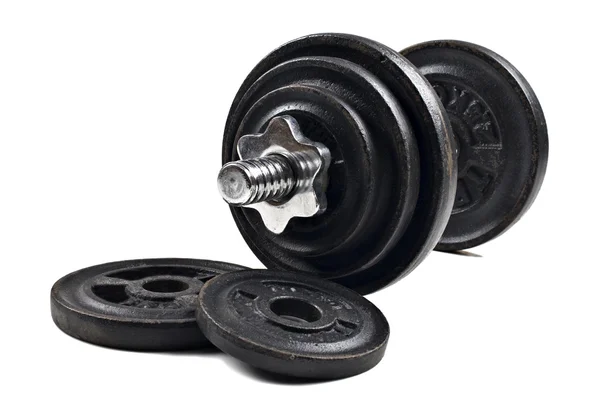 Black dumbbells and loose weights on a white background with space for text — Stock Photo, Image
