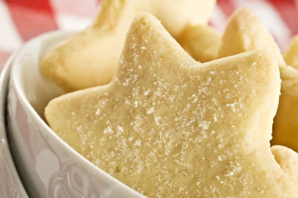 stock image Sugar coated shortbread cookies in star shapes stacked up - on a white background with space for text