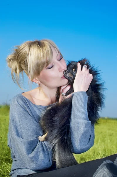 Beautiful woman with a small spitz — Stock Photo, Image