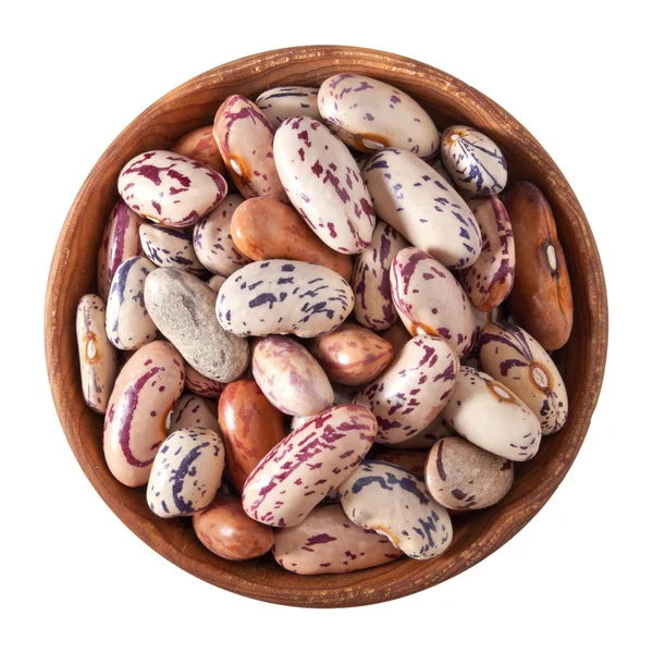 Dřevěná mísa plná skvrnité fazole izolovaných na bílém — Stock fotografie
