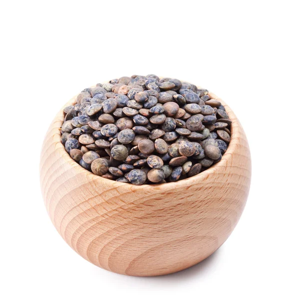 Wooden bowl full of French lentils isolated on white — Stock Photo, Image