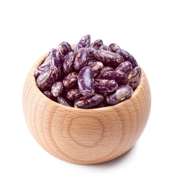 Wooden bowl full of speckled beans isolated on white — Stok Foto