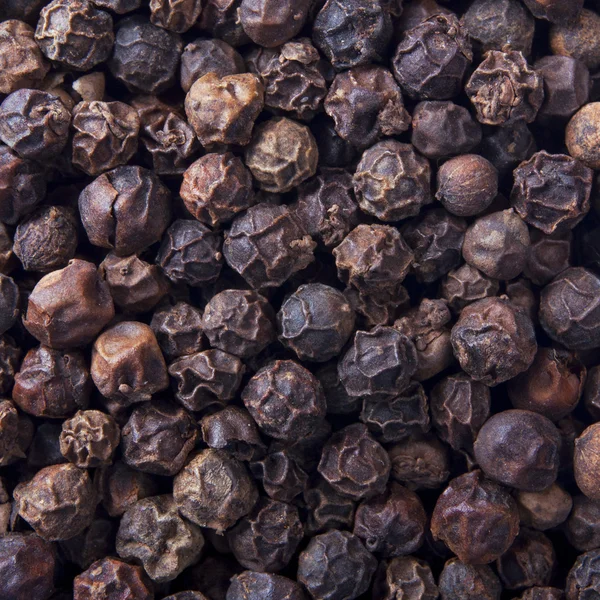 Black peppercorn background — Stock Photo, Image