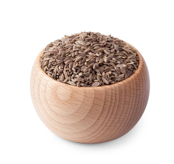 Tigela de madeira cheia de sementes de endro, isoladas no branco — Fotografia de Stock