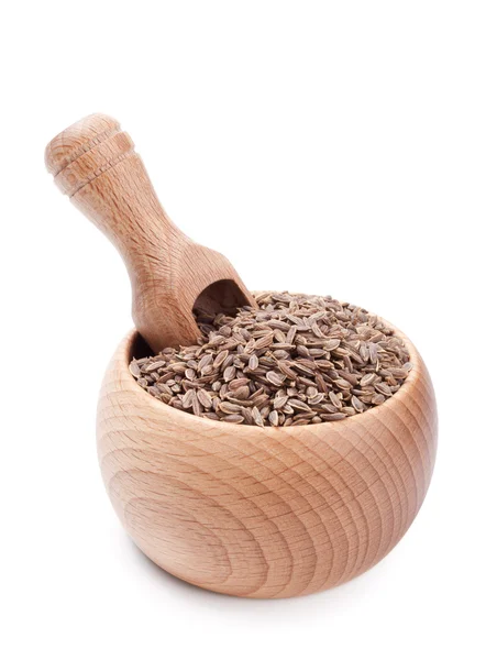 Colher de madeira na tigela cheia de sementes de endro — Fotografia de Stock