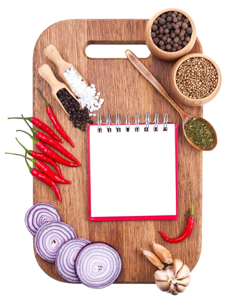 Open notebook and fresh vegetables on an old wooden cutting boar — Stock Photo, Image