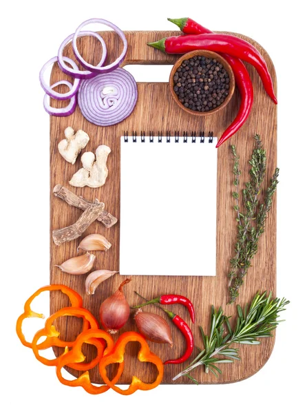 Notebook for recipes and spices on wooden cutting board — Stock Photo, Image